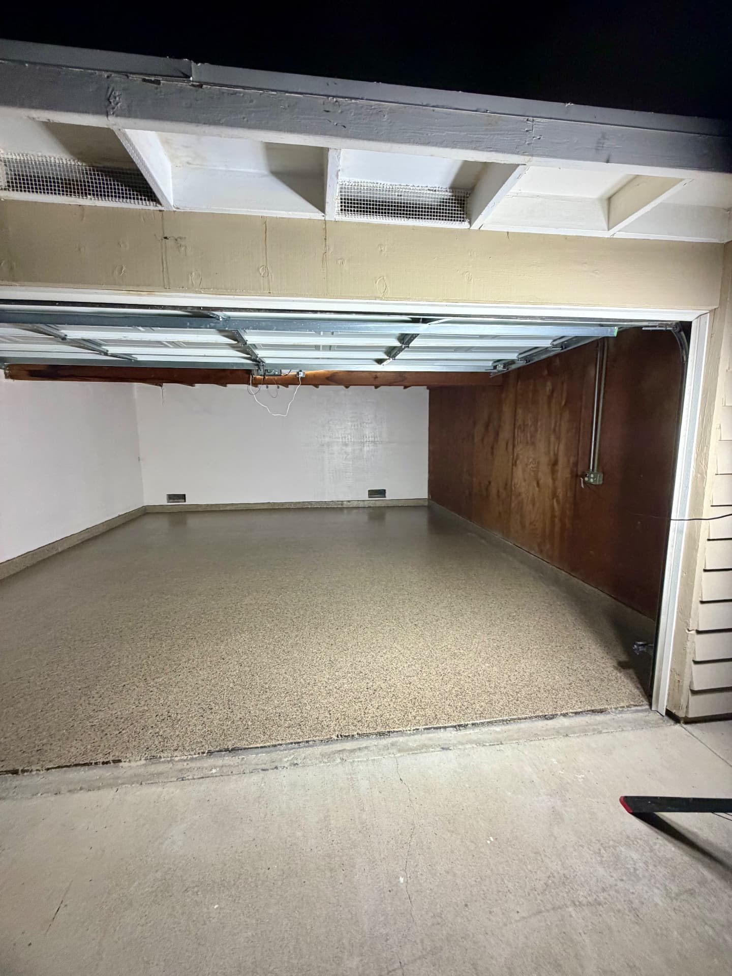 One-Car Flake Garage — Prepped and crack-filled slab, 100% solids base, full-broadcast 1/4" tan and beige flake blend, polyaspartic clear top coat